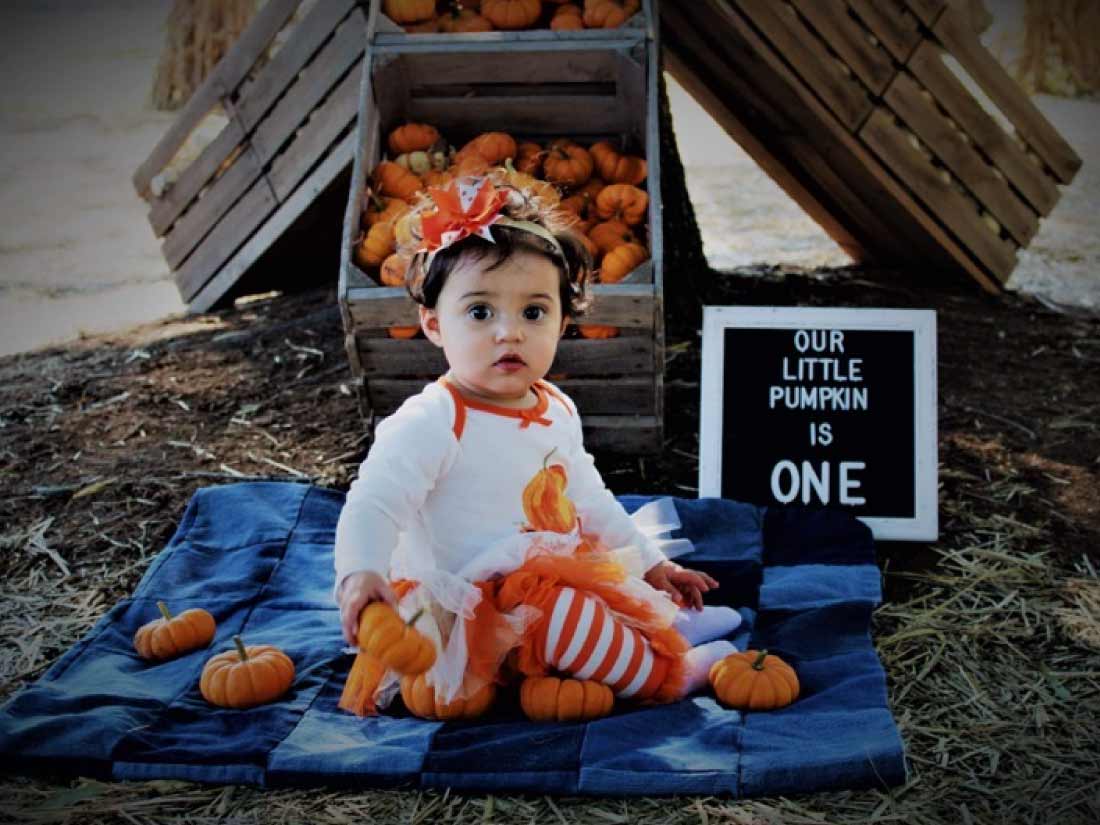 Child with sign saying they are 1 year old